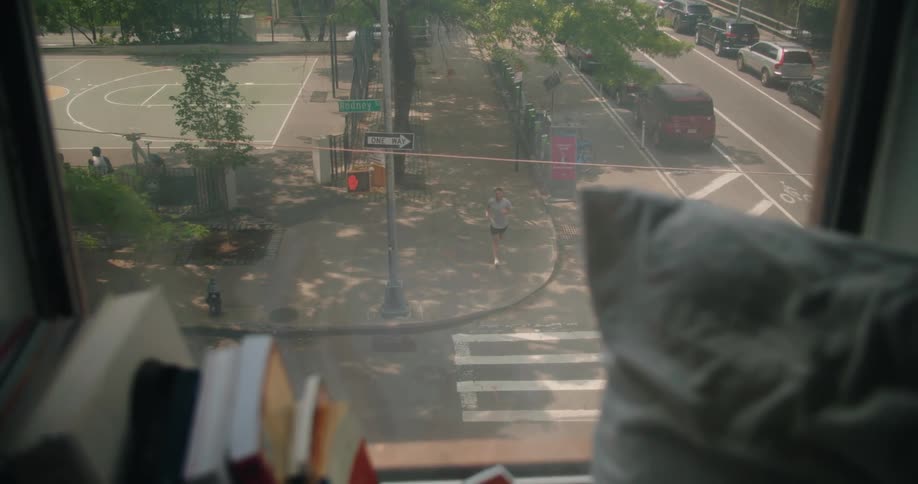 An apartment window overlooks a busy intersection