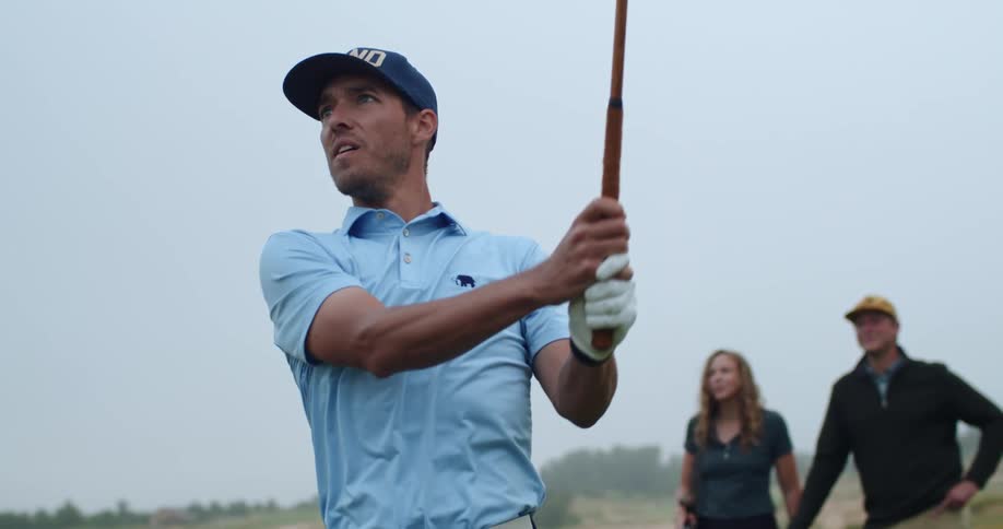 A man drives the golf ball
