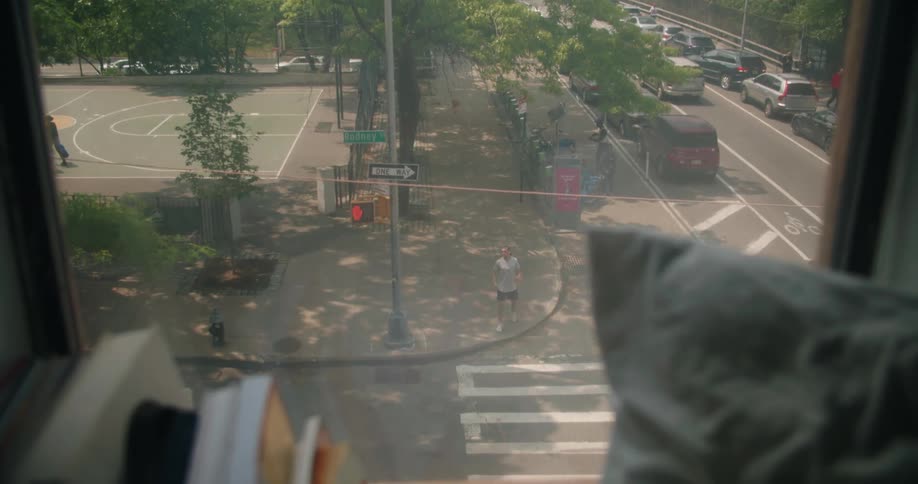 An apartment window looks onto a busy intersection below