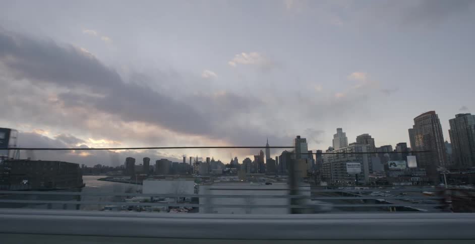 The sun is setting behind the clouds of this city