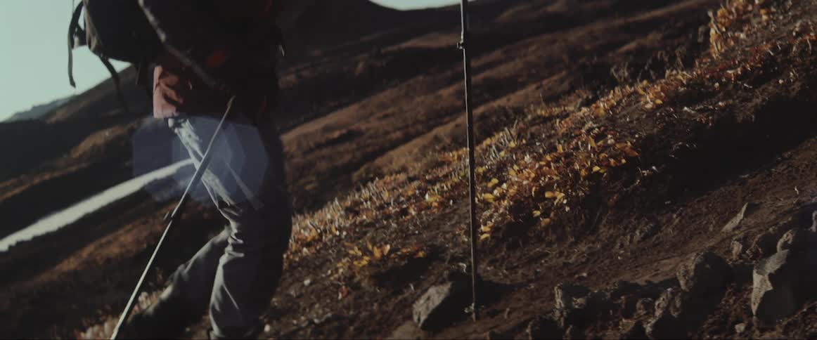 A man hikes up the side of a mountain