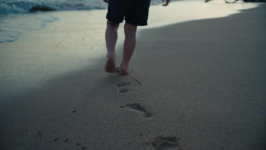 A child is walking on the beach