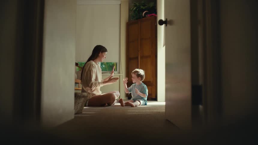 A mother and son playing games with each other