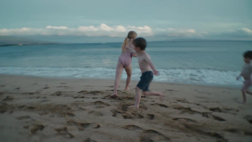 Children run around the beach