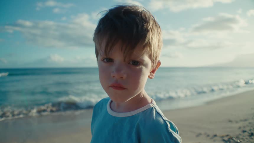The view is of a portrait of a kid that is on the beach