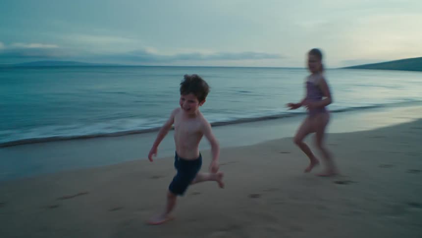 The view is of a portrait of kids running on the beach