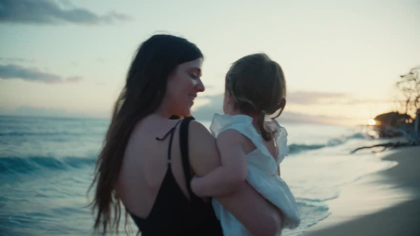 The view is of a portrait of mother and kid that are on the beach
