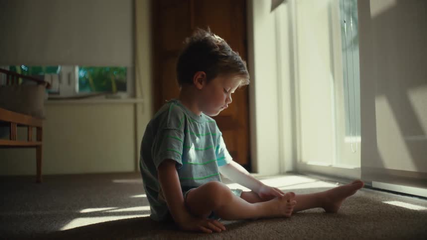 A sitting child coughs