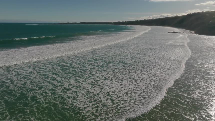 Aerial view of ocean waves are displayed in spring