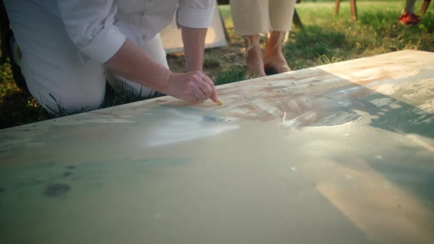 A person is painting on the canvas