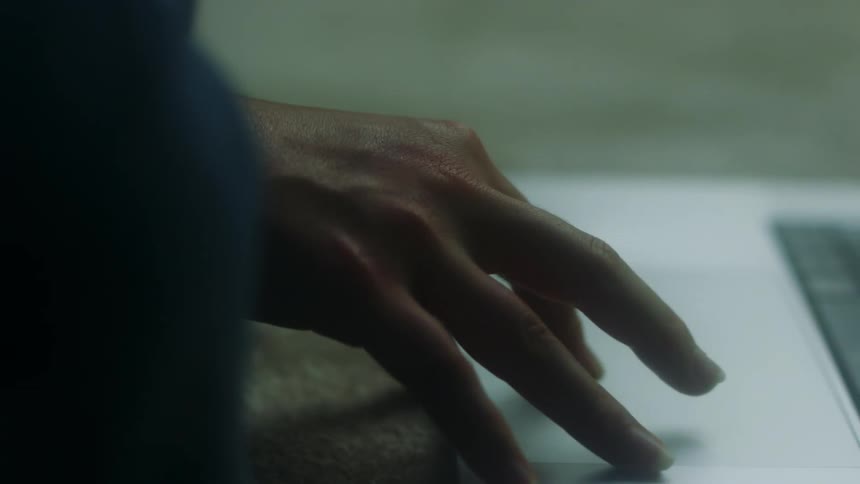 A person using a laptop touchpad