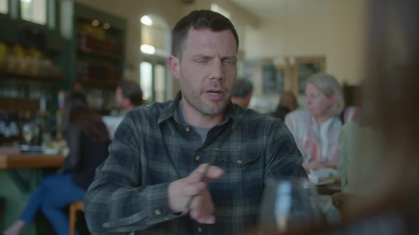 A man is talking with someone in the restaurant