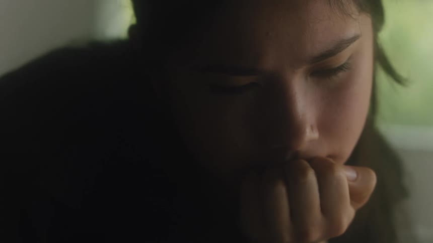 The view is of a portrait of a teenager that is inside of her room