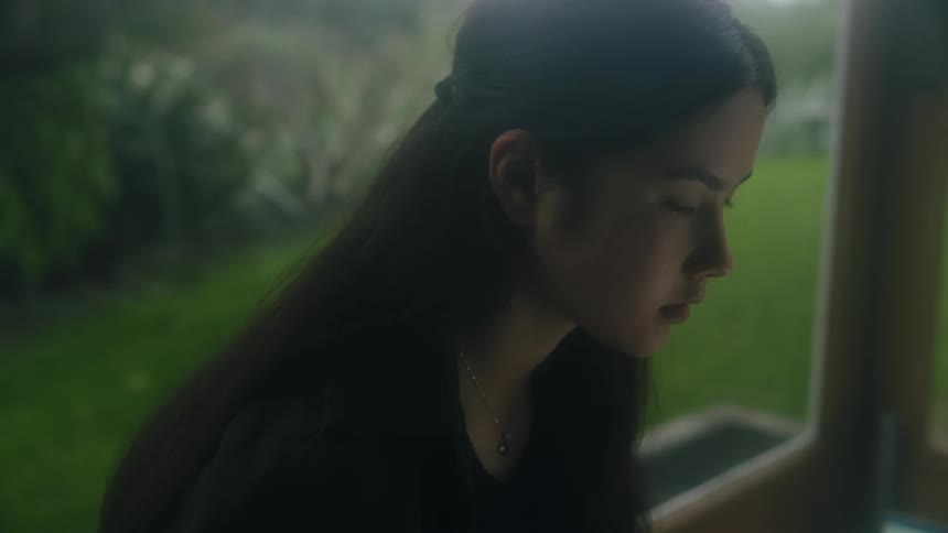 A woman sitting in front of a window
