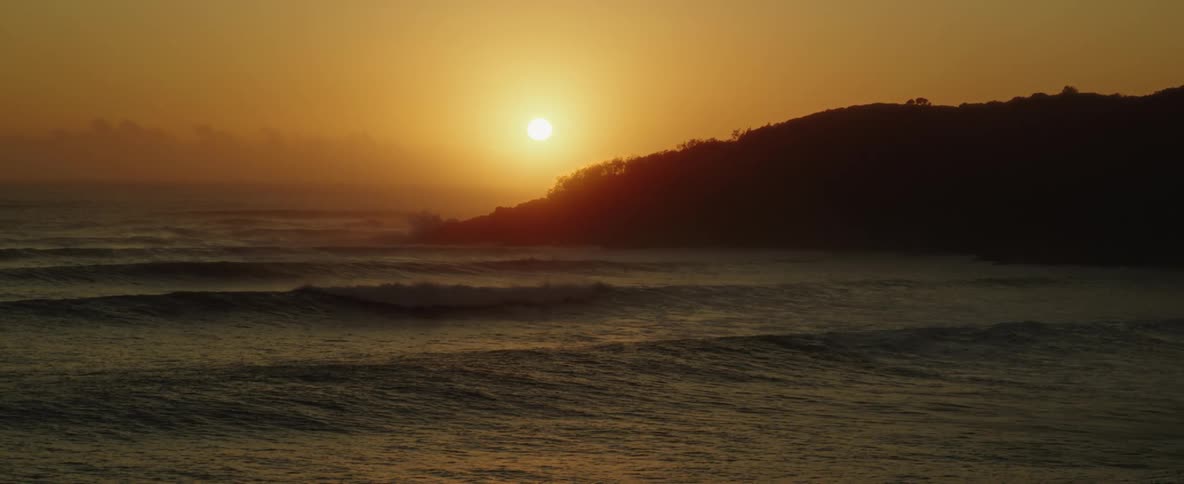 The sun is rising over the island