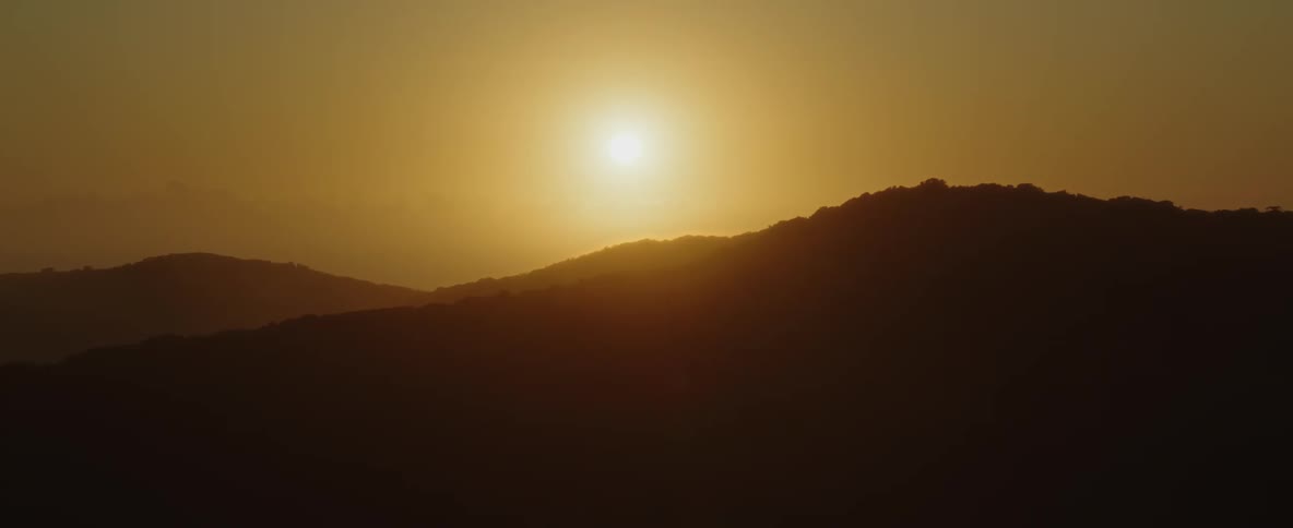 The sun over canyon peaks