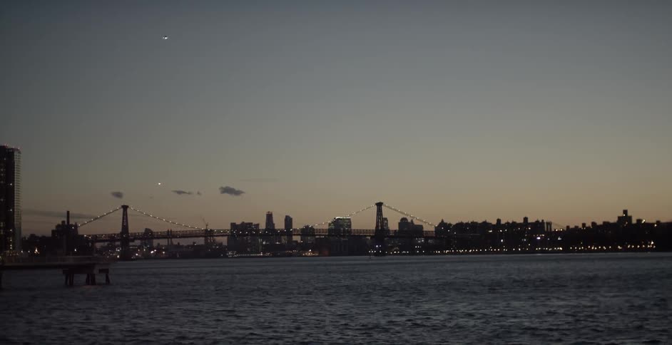 Beyond the bridge is a city at dawn