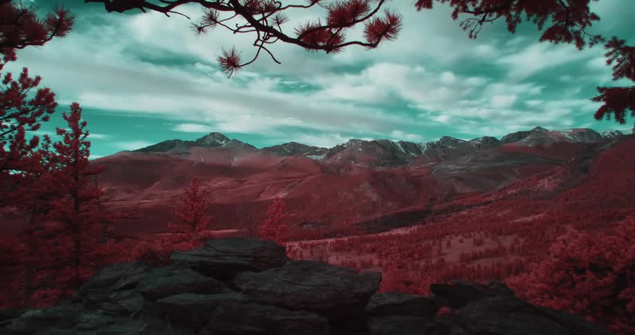 Colored filter tints landscape red under a green tinted cloudy sky
