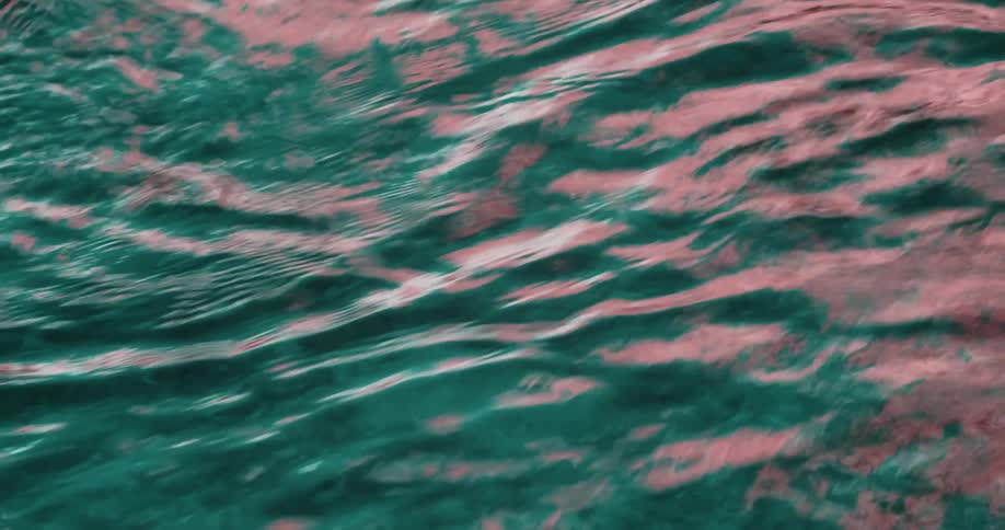 A current passing furiously fast in shades of green water