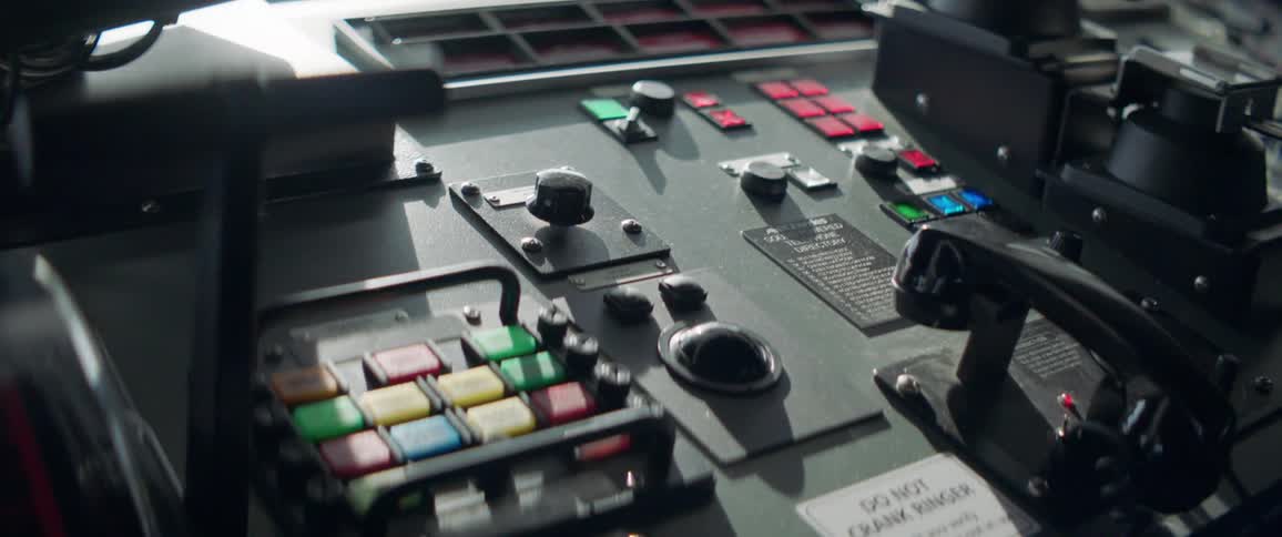An old fashioned control panel contains multiple colored buttons and dials along with an incorporated telephone receiver