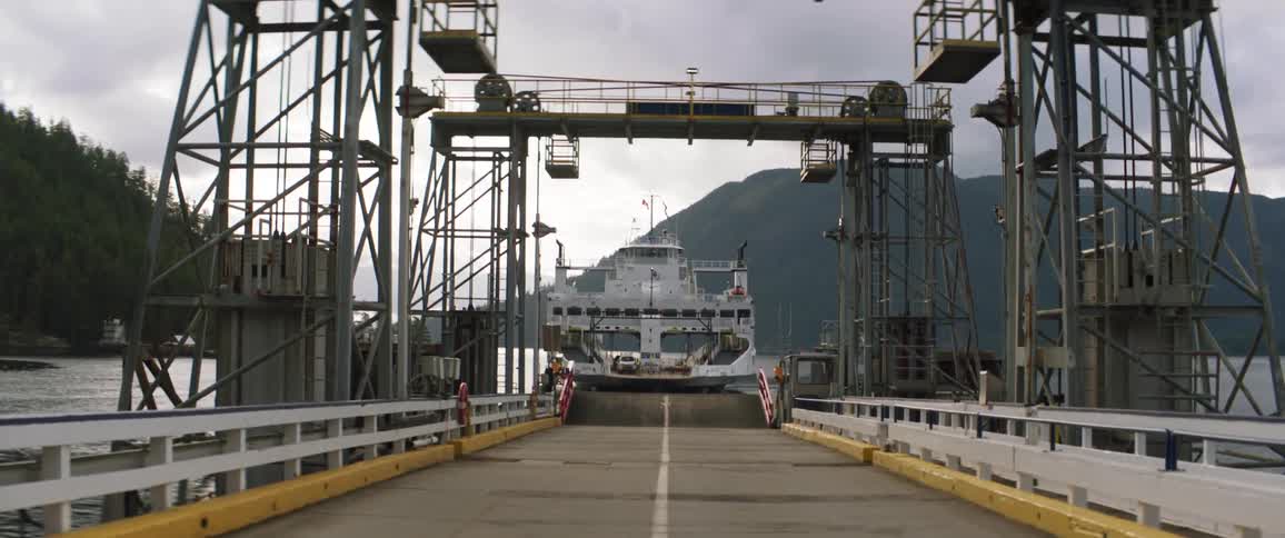 A ferry pulling up to a dock