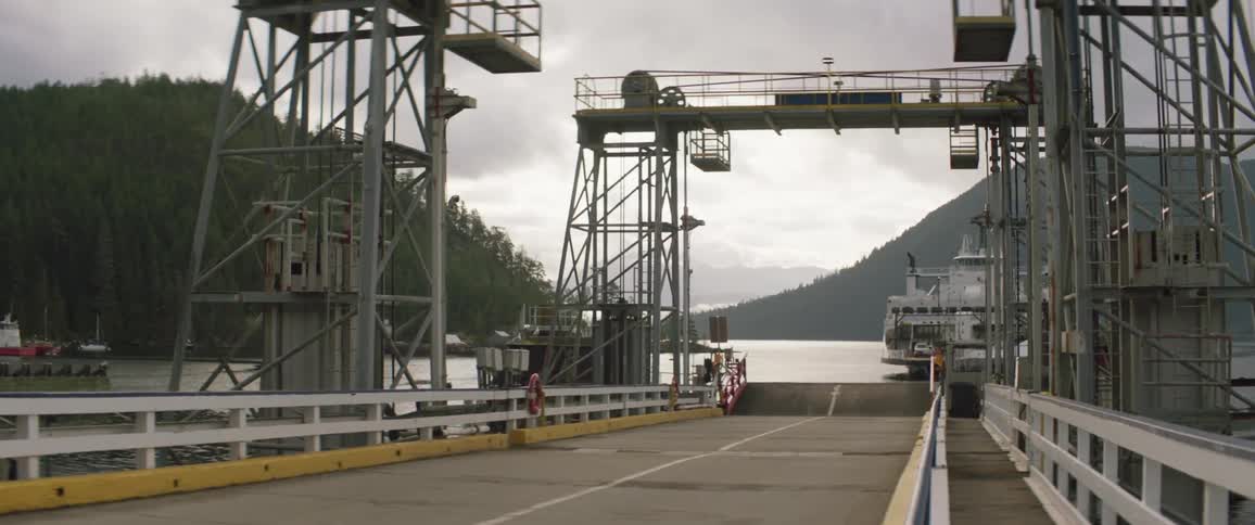 A ferry is sailing by the bridge