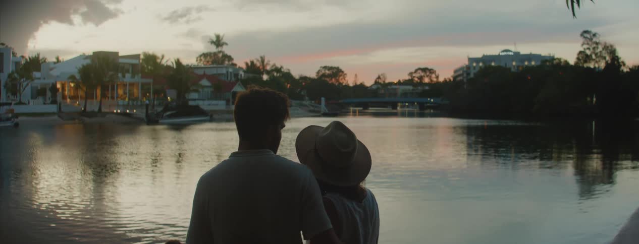 A couple kissing near water