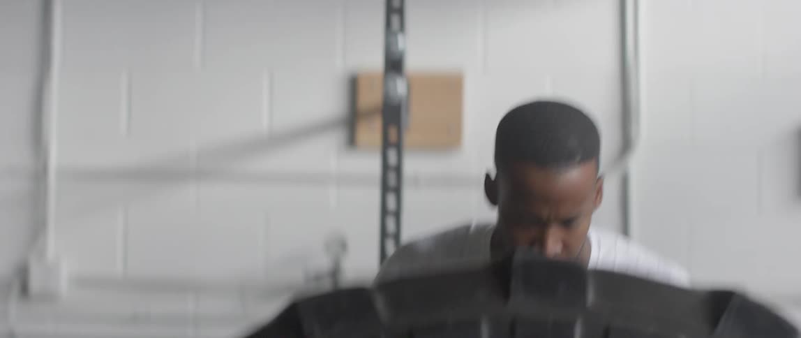 Man lifting and flipping a heavy tire