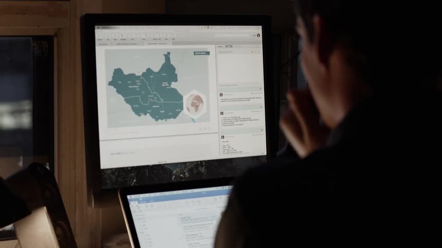 A young man looks at his computer screen