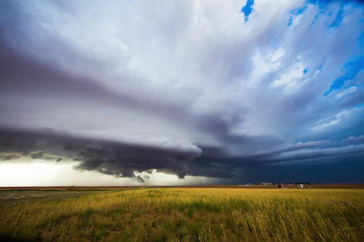 Storm clouds form over a field