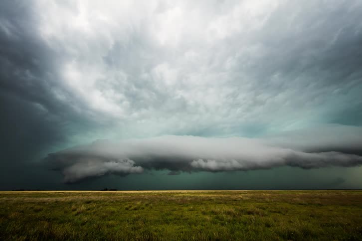 Storm clouds sweeping over field