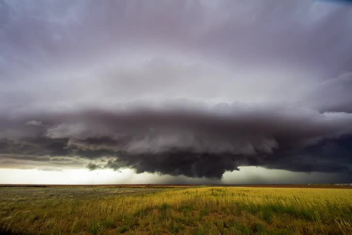 Storm clouds form over a field