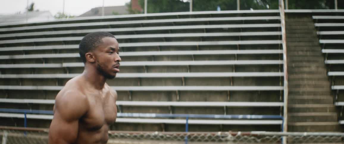 A man is jogging outdoors in spring