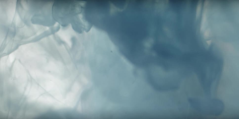 A blue fluid swirls and flows