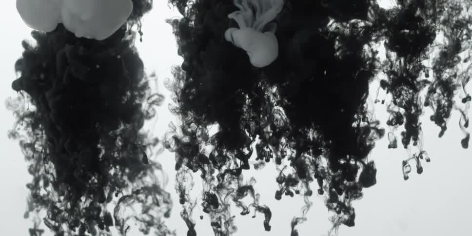 Ink like substance floats down through the water