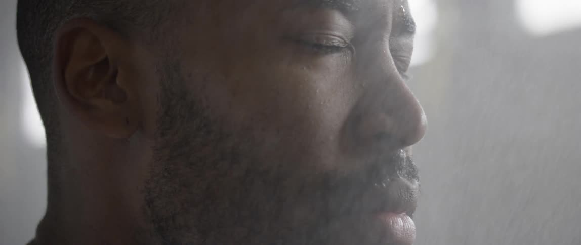 Mist falls on a man's face