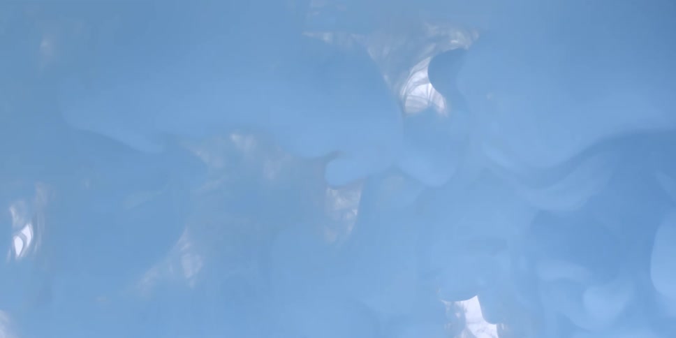 Blue and white clouds float in liquid