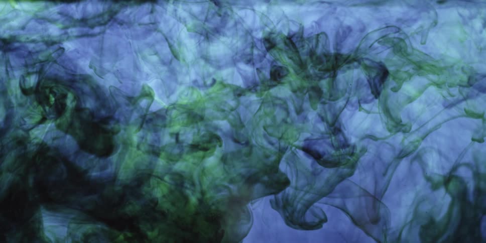 An abstract video of purple and green smoke