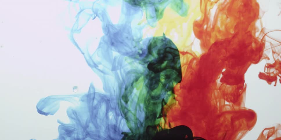 Colorful dye flows and swirls in water