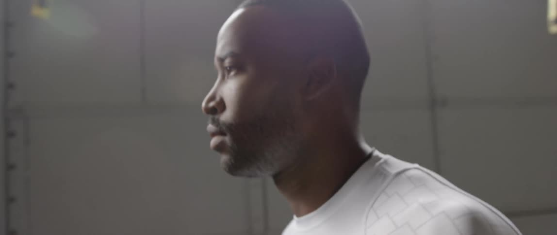 A man is walking past a wall