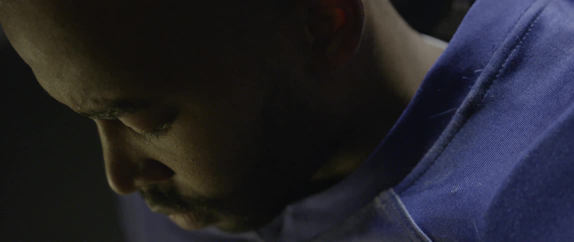 A man is looking down blinking