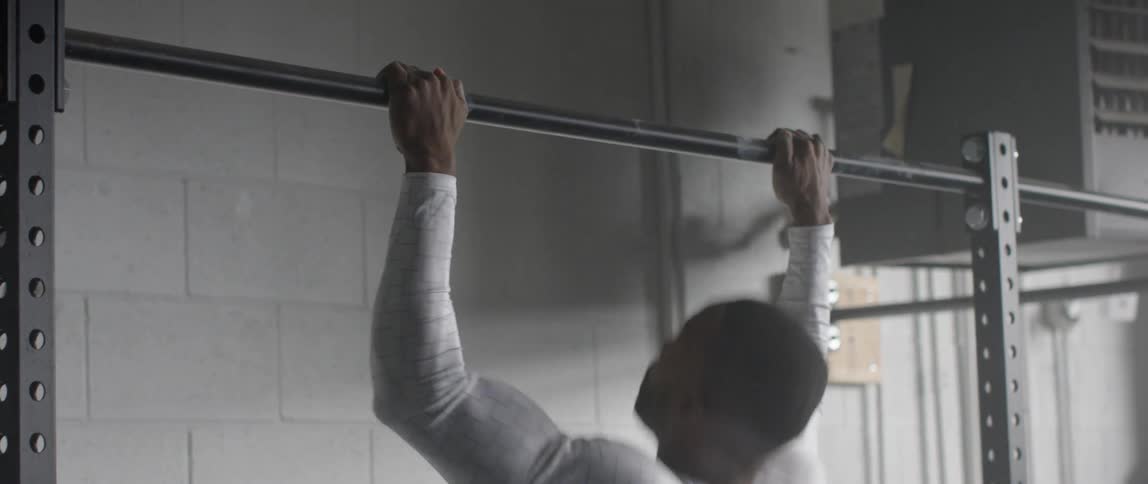 A man is doing pull ups on a bar