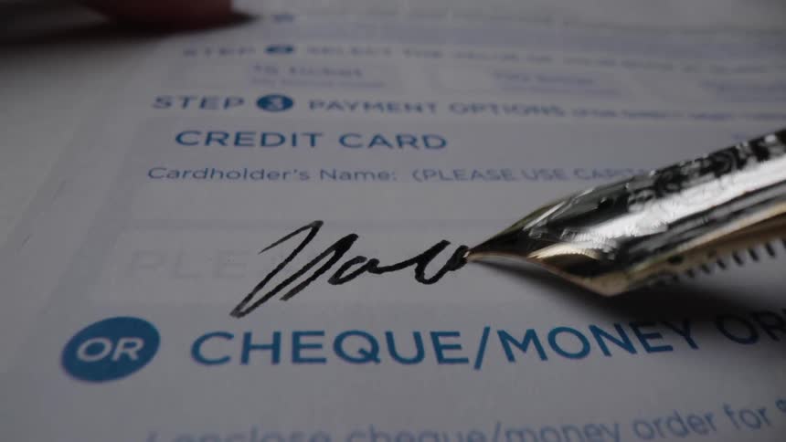 Fountain pen inks signature on payment slip