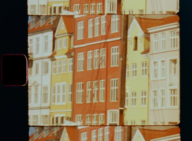 Brightly painted apartment buildings stretch under blue sky