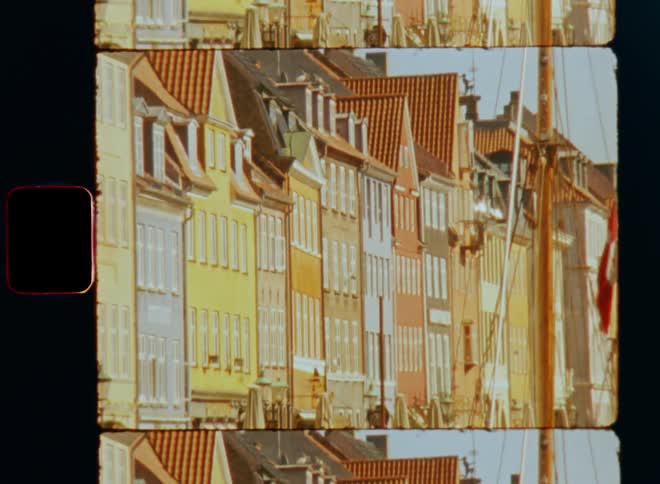 A row of apartment buildings are on the film slide