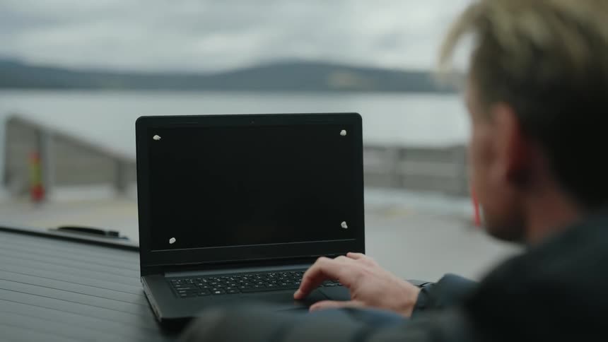 A man is typing on the laptop