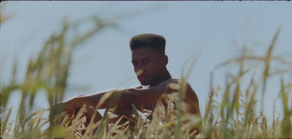 A man is sitting in the grass