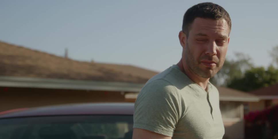 A man is talking by his car