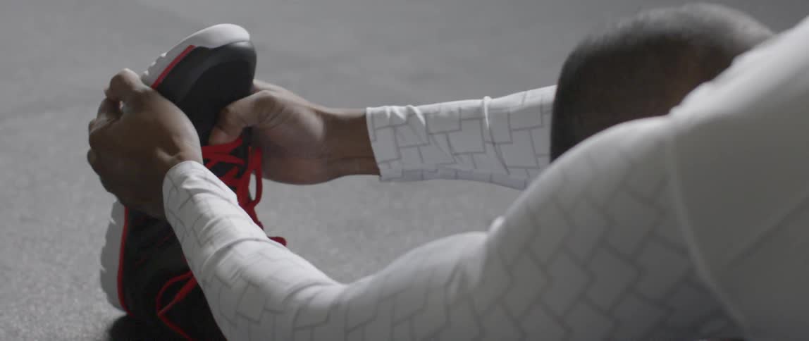 A man stretches over his leg