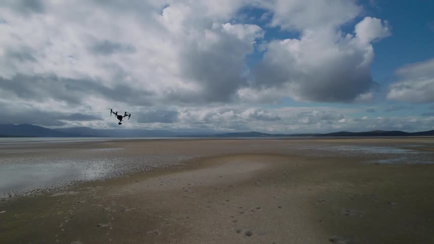 A drone flies over the desert